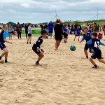 Boys playing beach soccer in Bridlington, England